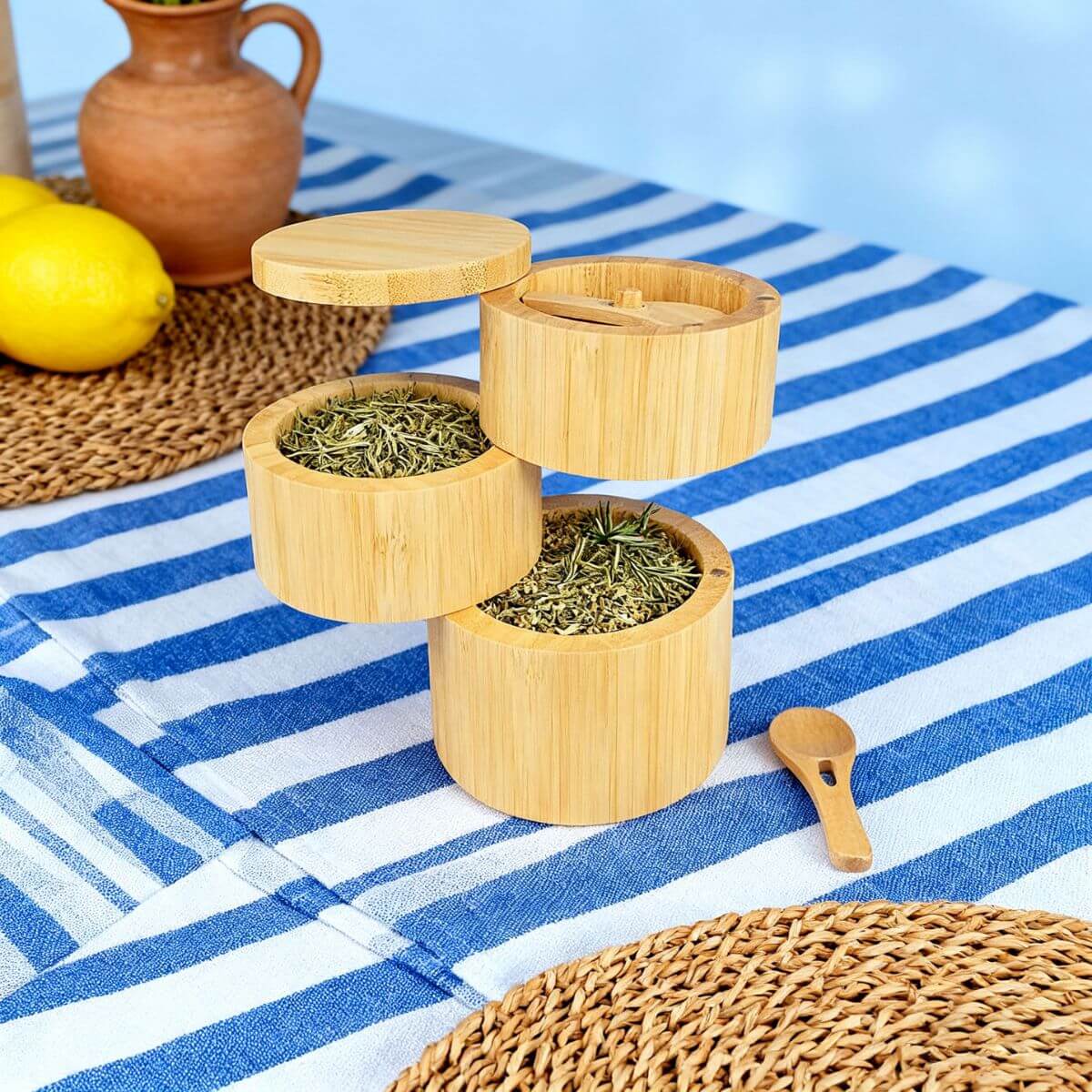 3-tier revolving bamboo spice tower on a kitchen countertop with spices.