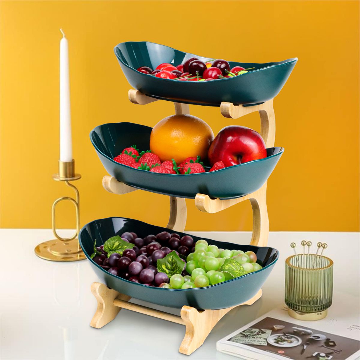 3-tier wave bowl fruit stand on a living room coffee table with fruits and snacks.