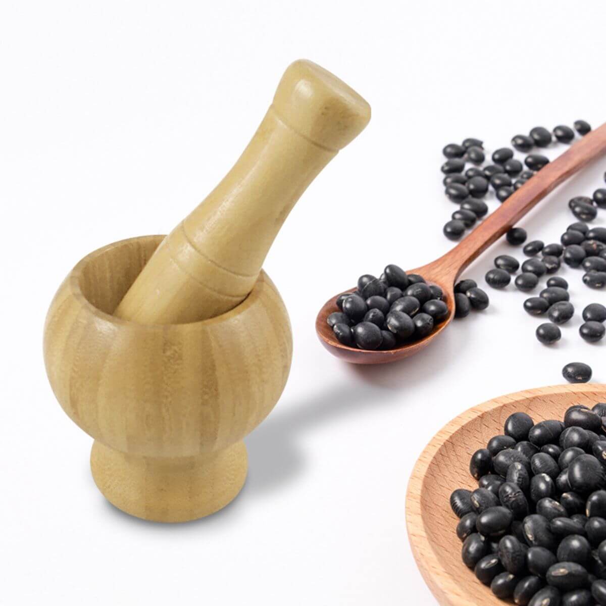 Medium bamboo mortar and pestle used for crushing black beans.