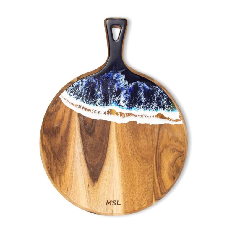 Round acacia wood and blue epoxy resin serving board with handle pointing up, front view on white background.